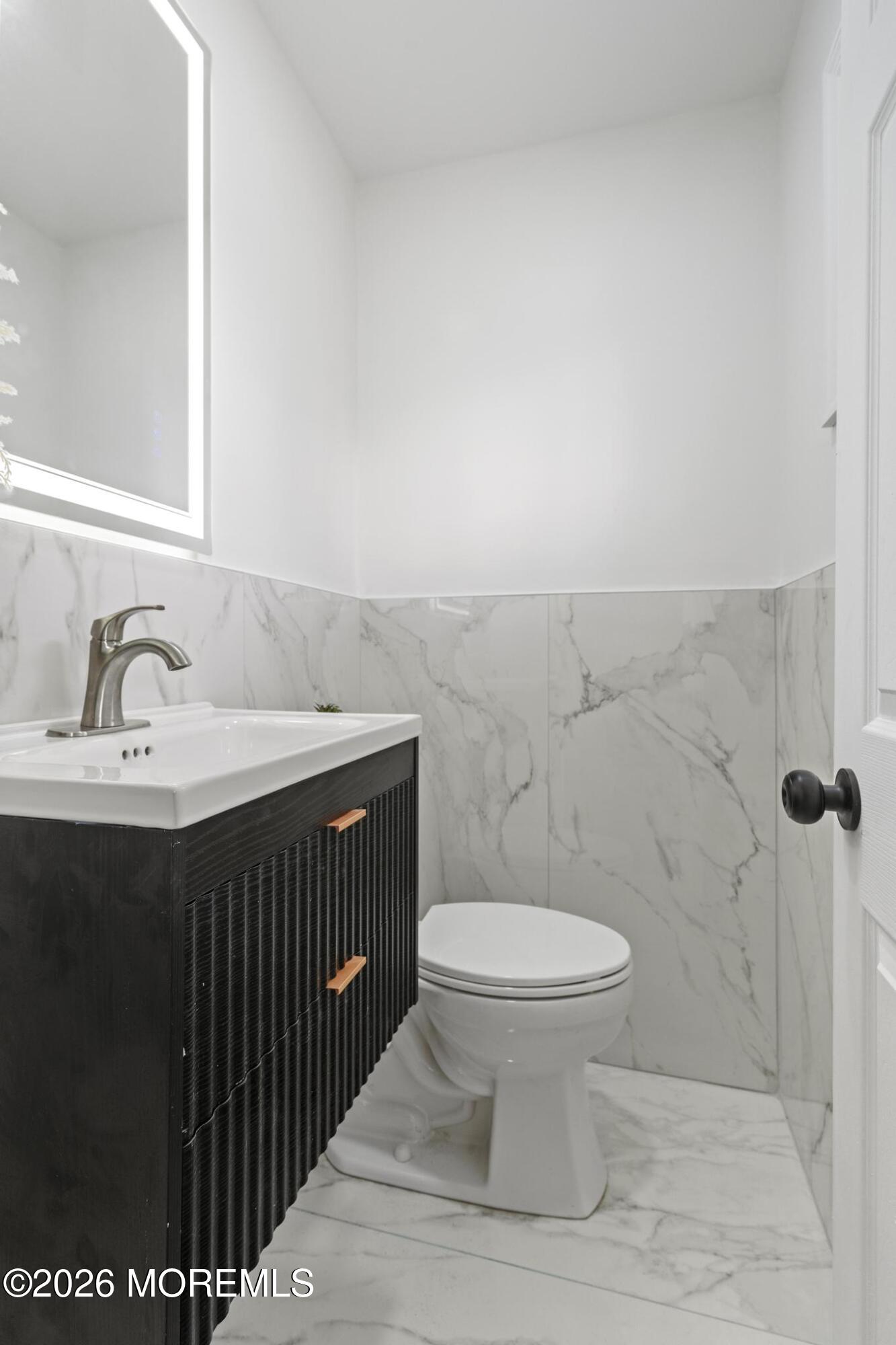 20 Kenneth Terrace Neptune Township, NJ 07753 - Photo 14 of 34 a bathroom with a sink toilet and a mirror