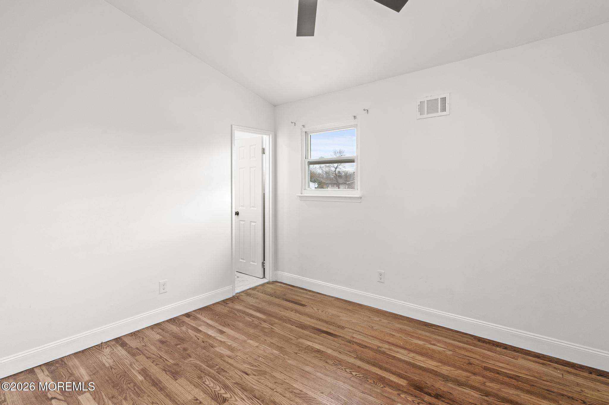 20 Kenneth Terrace Neptune Township, NJ 07753 - Photo 16 of 34 a view of empty room with wooden floor