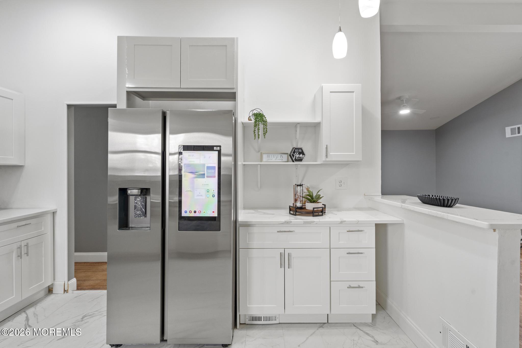 20 Kenneth Terrace Neptune Township, NJ 07753 - Photo 22 of 34 a kitchen with white cabinets and refrigerator