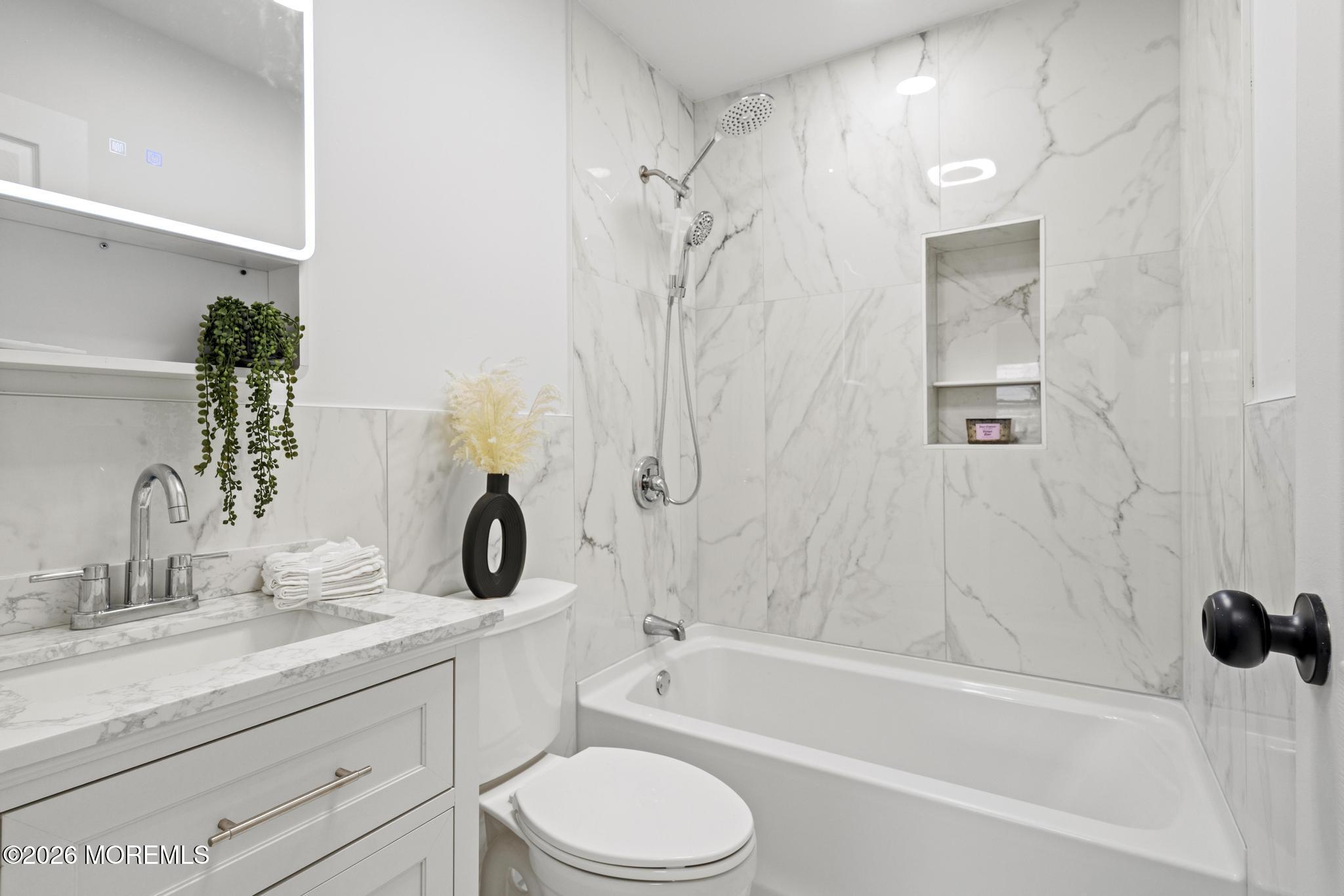 20 Kenneth Terrace Neptune Township, NJ 07753 - Photo 30 of 34 a bathroom with a granite countertop sink a toilet and shower