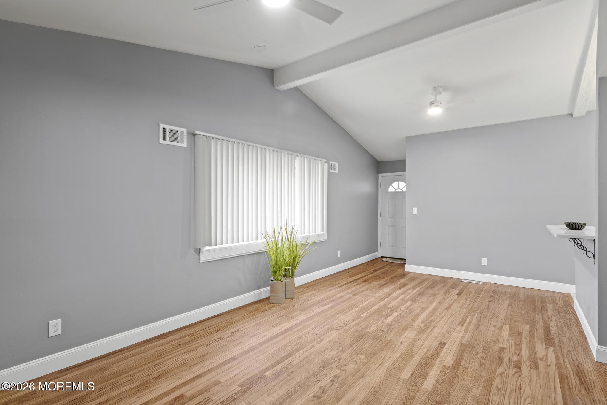 20 Kenneth Terrace Neptune Township, NJ 07753 - Photo 3 of 34 wooden floor in an empty room with a window