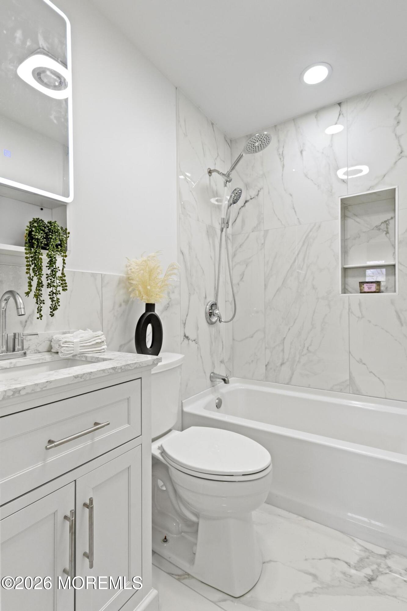 20 Kenneth Terrace Neptune Township, NJ 07753 - Photo 33 of 34 a bathroom with a sink a toilet and a bathtub
