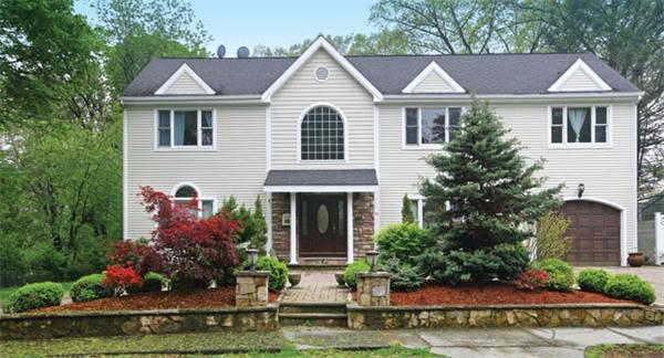 65 Indian Ridge Road Newton, MA 02459 - Photo 7 of 9 a front view of a house with a yard and potted plants