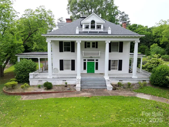 a view of a house with a yard porch and sitting area