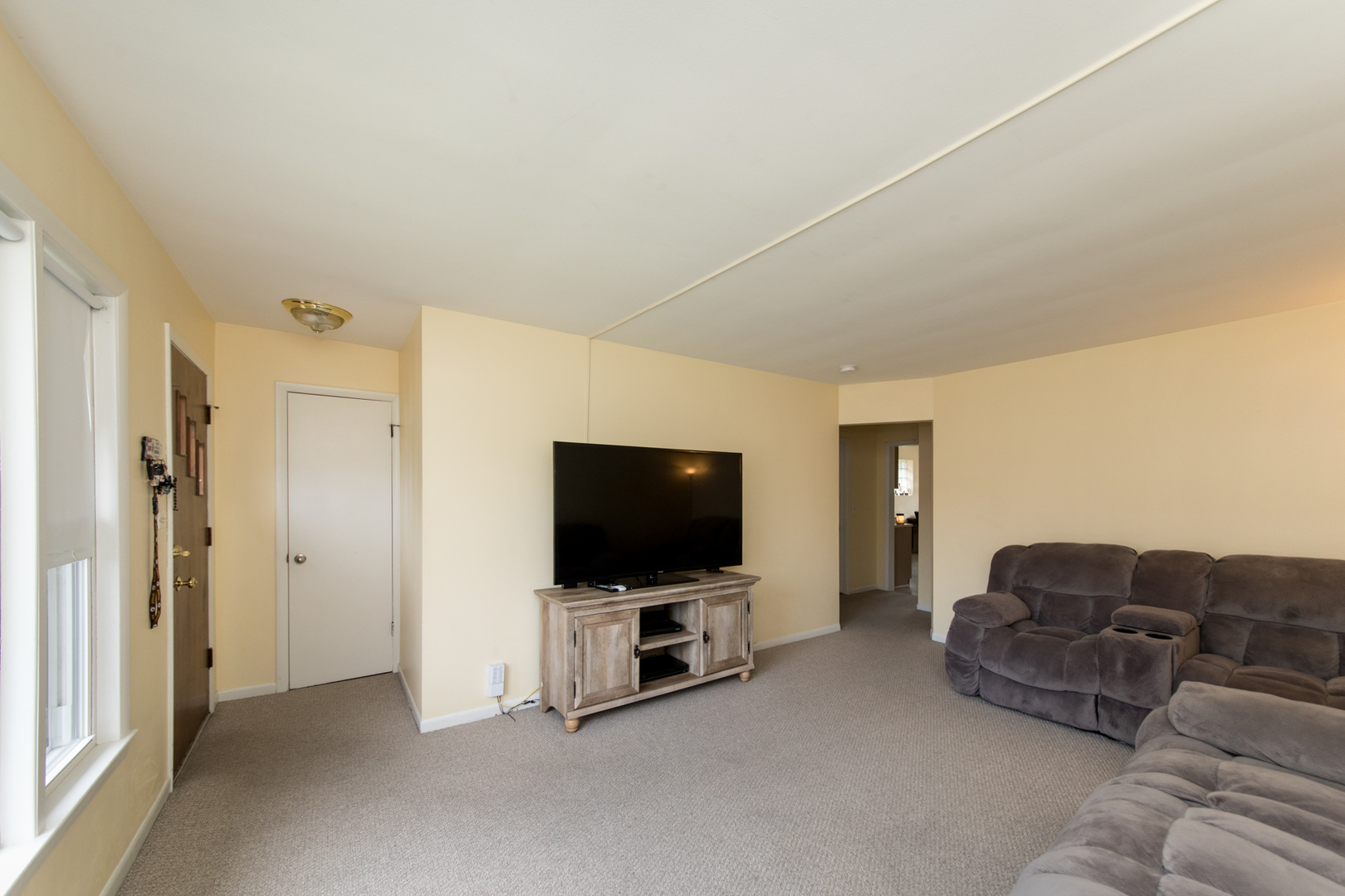 3749 Main Street Skokie, IL 60076 - Photo 3 of 17 a living room with furniture and a flat screen tv
