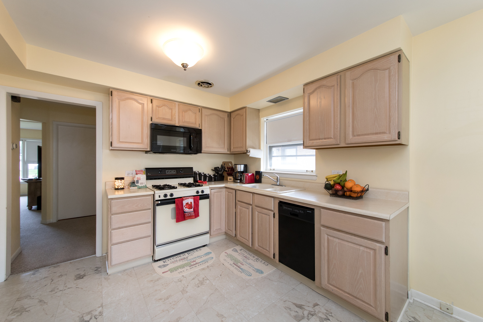 3749 Main Street Skokie, IL 60076 - Photo 7 of 17 a kitchen with sink a microwave and cabinets