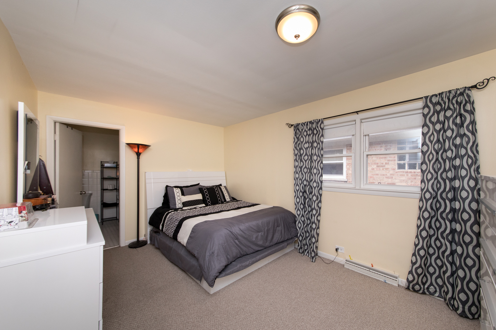 3749 Main Street Skokie, IL 60076 - Photo 9 of 17 a bedroom with a bed and a large mirror