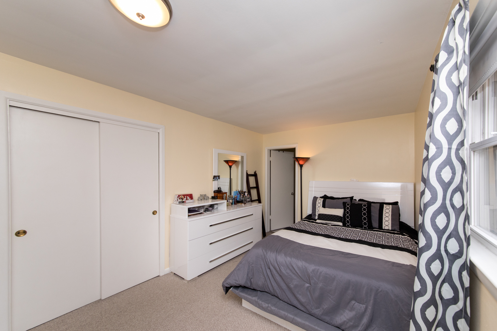 3749 Main Street Skokie, IL 60076 - Photo 10 of 17 a bedroom with a bed and a television