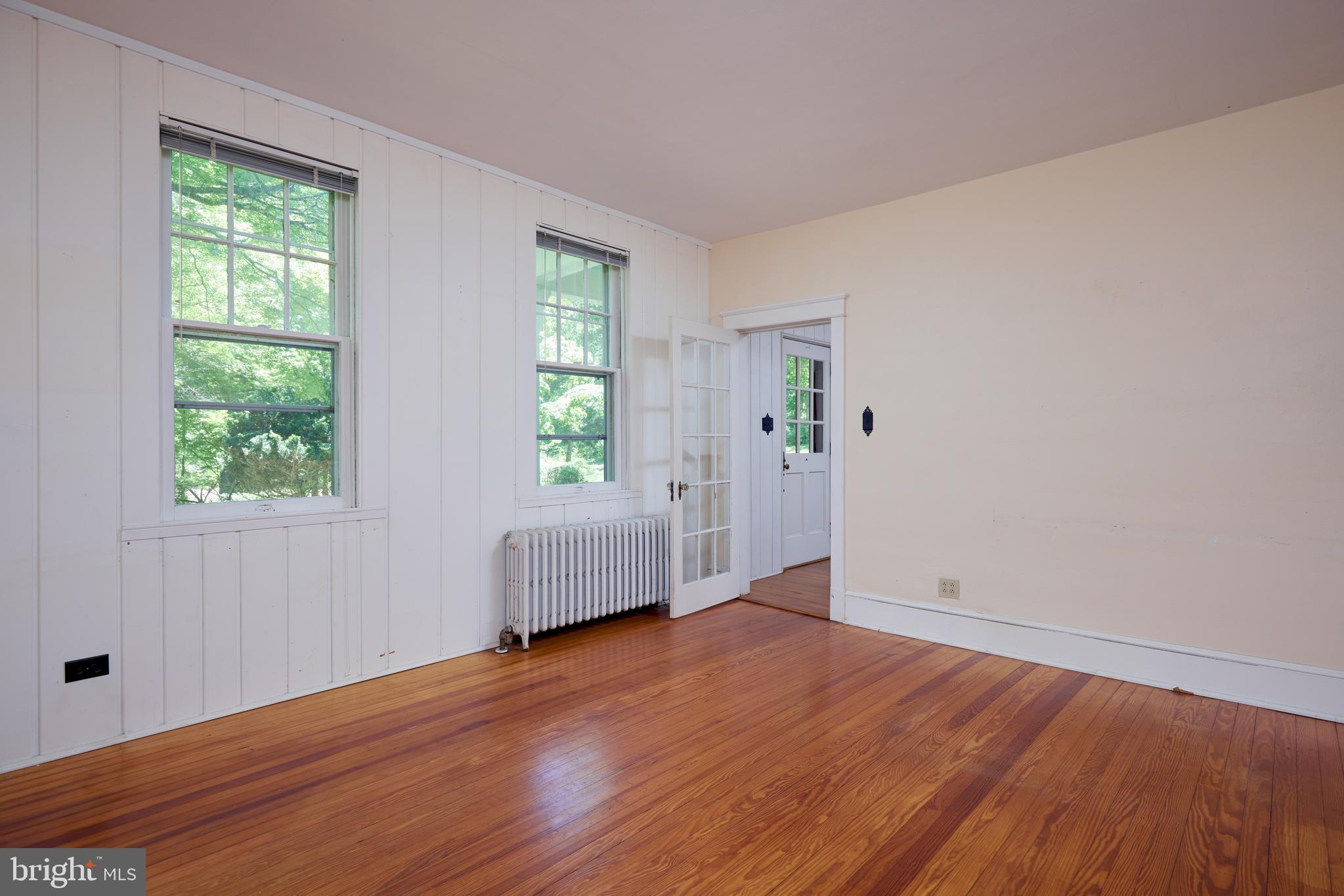 22500 Old Hundred Road Barnesville, MD 20838 - Photo 16 of 60 an empty room with wooden floor and windows