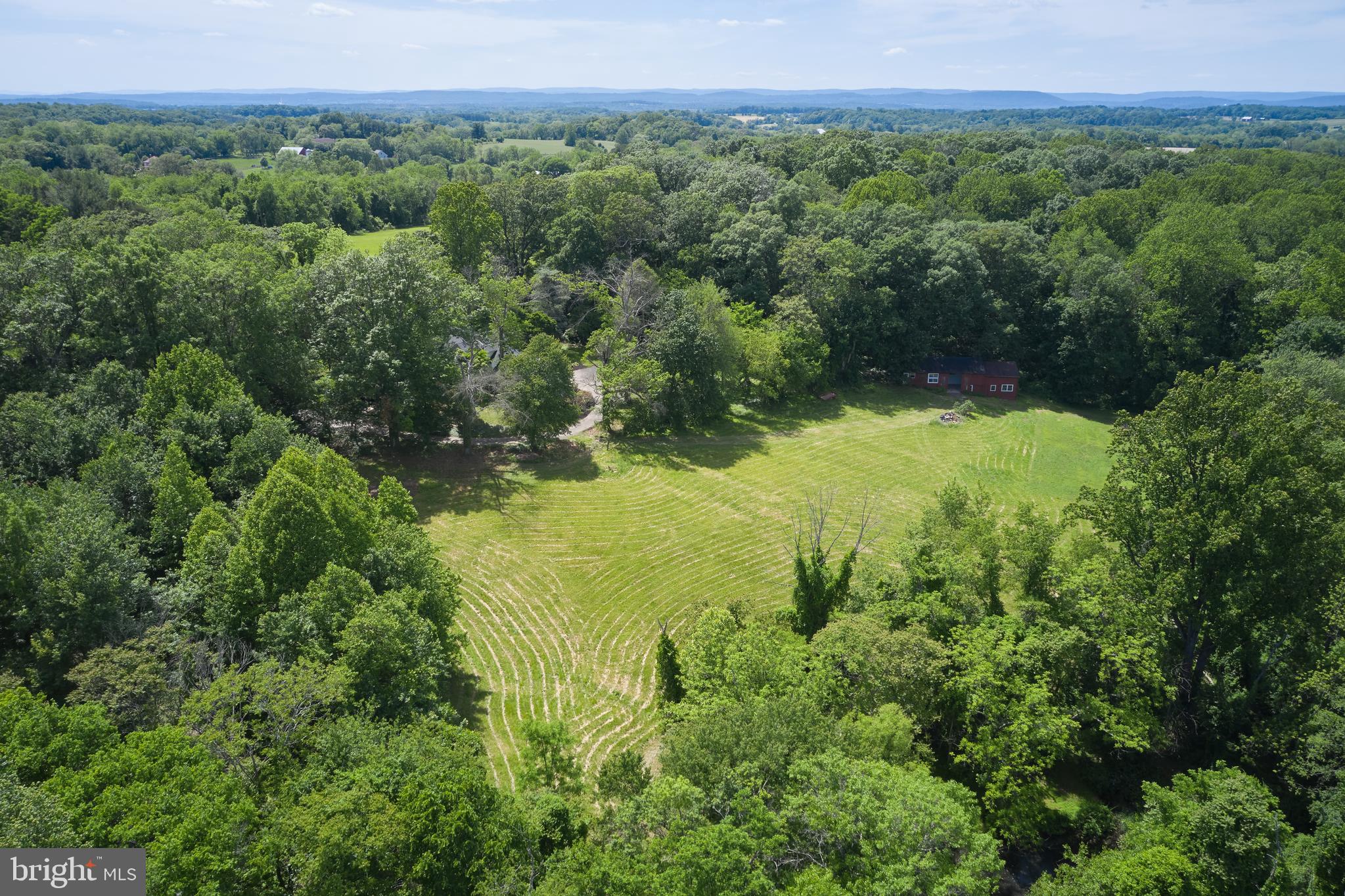 22500 Old Hundred Road Barnesville, MD 20838 - Photo 43 of 60 a view of a lush green forest with trees and some houses