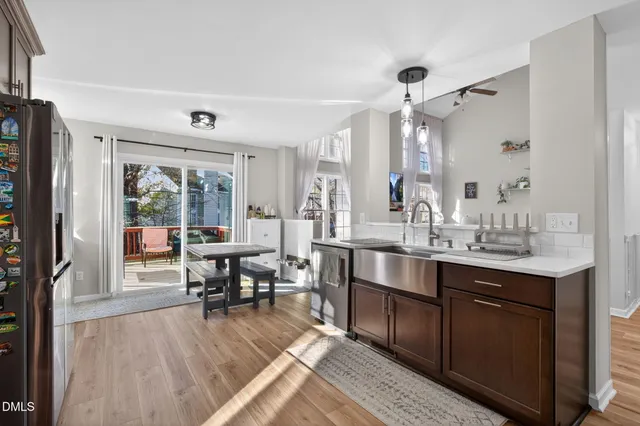 a kitchen with a table chairs and cabinets