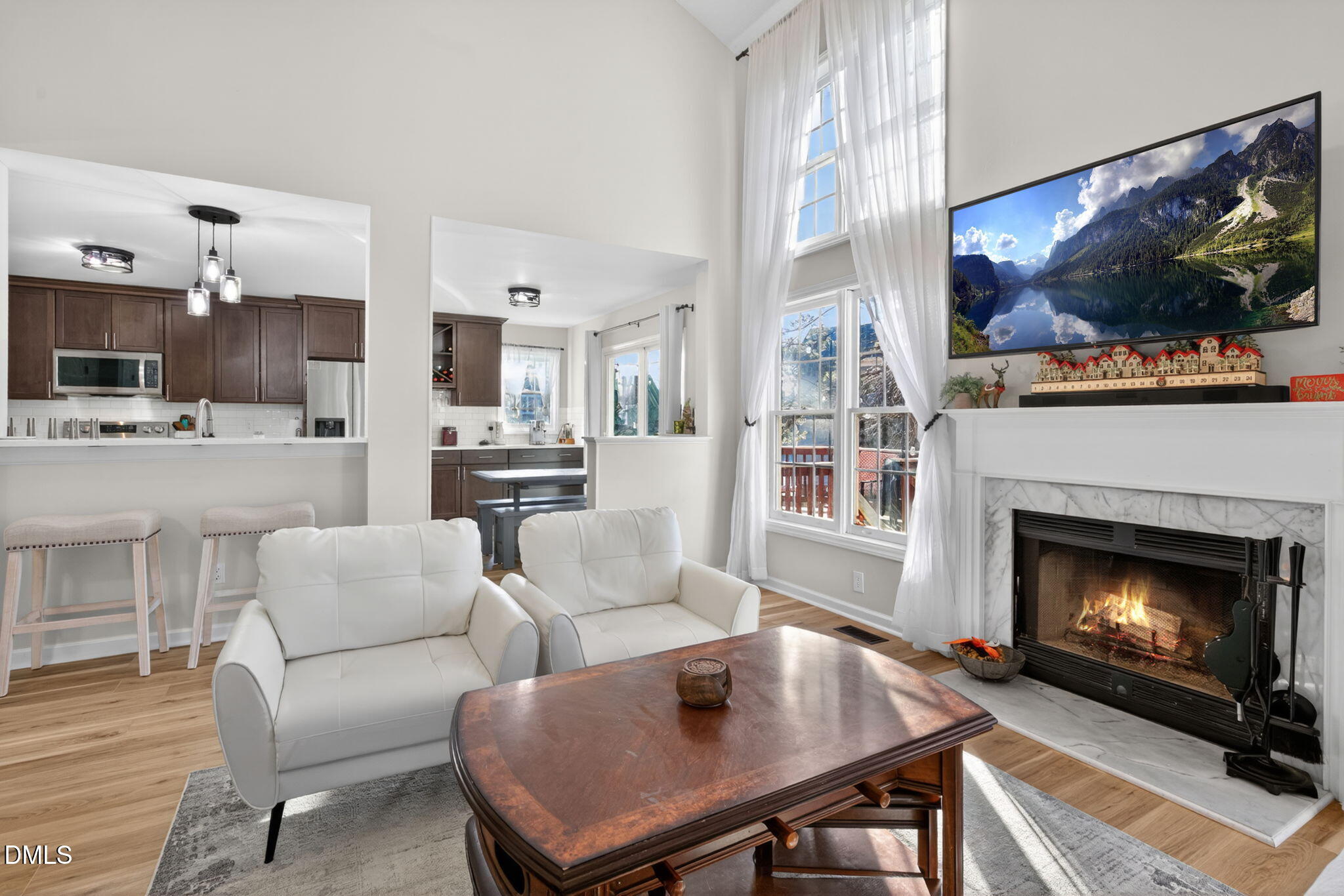 713 Marsh Grass Drive Raleigh, NC 27610 - Photo 15 of 41 a living room with furniture a flat screen tv and a fireplace