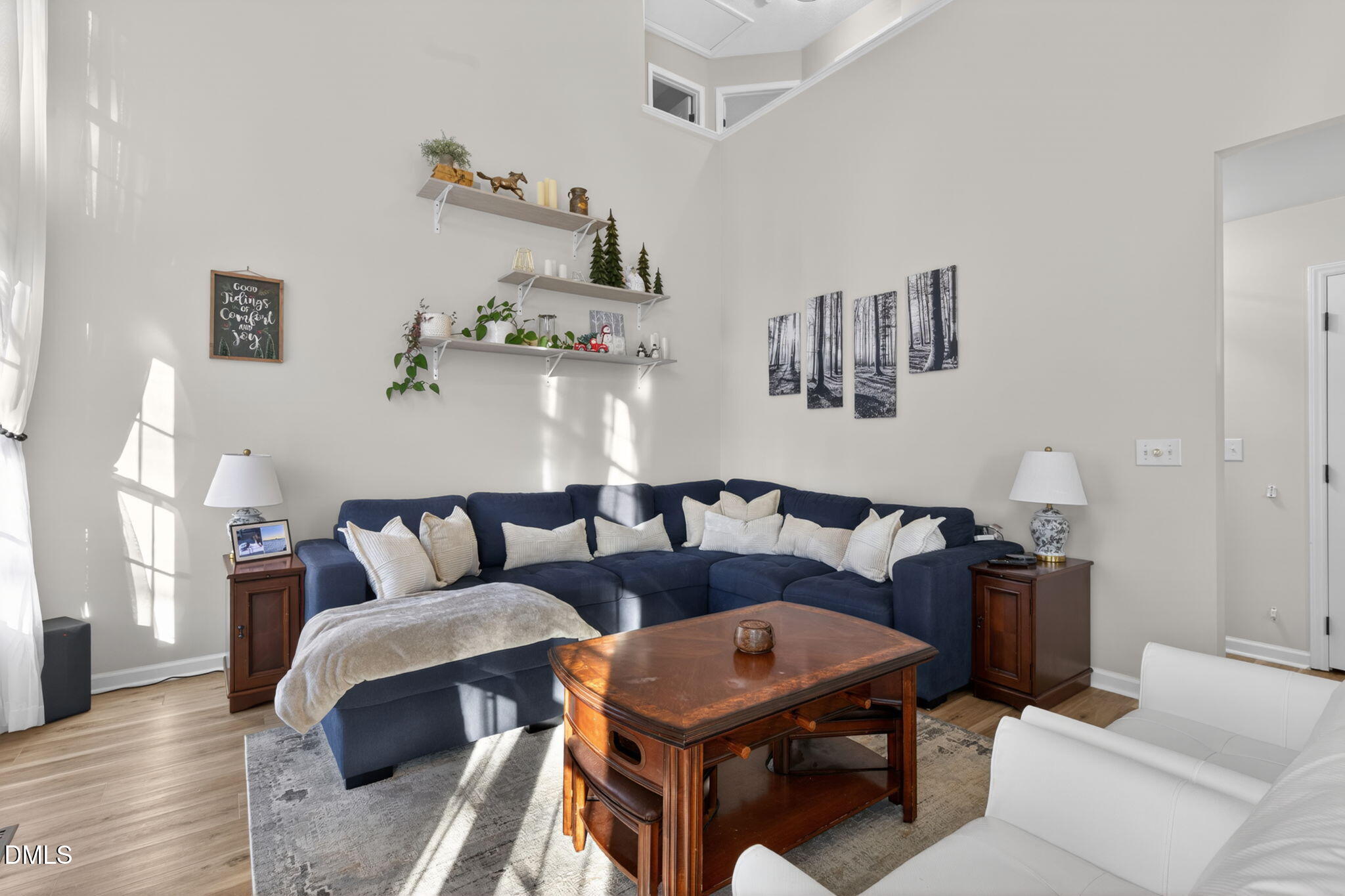 713 Marsh Grass Drive Raleigh, NC 27610 - Photo 17 of 41 a living room with furniture and painting on the wall