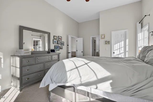 a spacious bedroom with a bed and a dresser