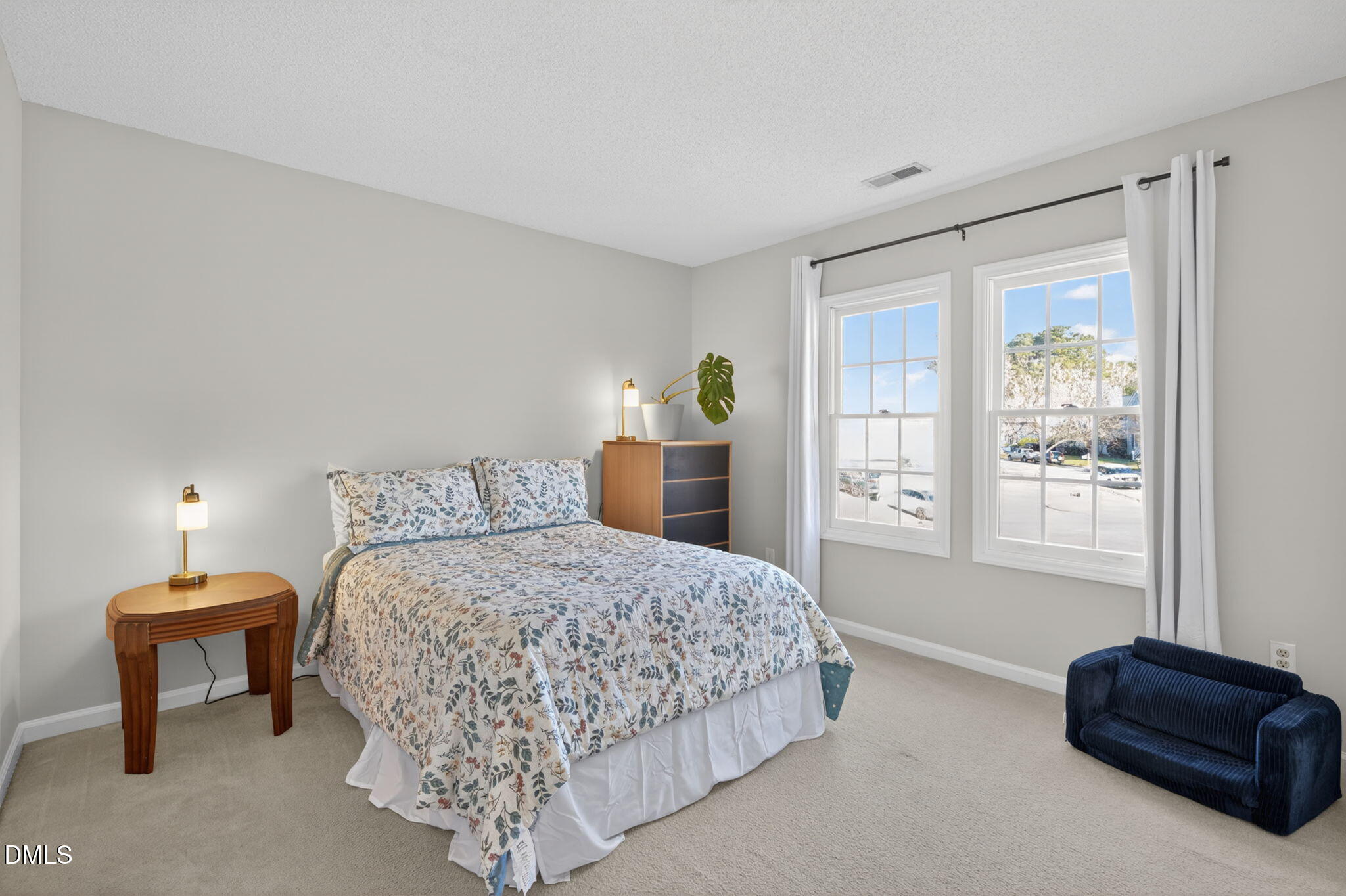 713 Marsh Grass Drive Raleigh, NC 27610 - Photo 29 of 41 a bedroom with a bed and a couch next to a window