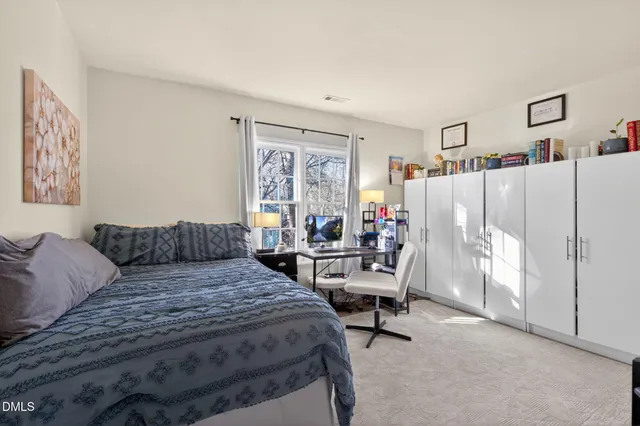 a bedroom with a bed and a couch