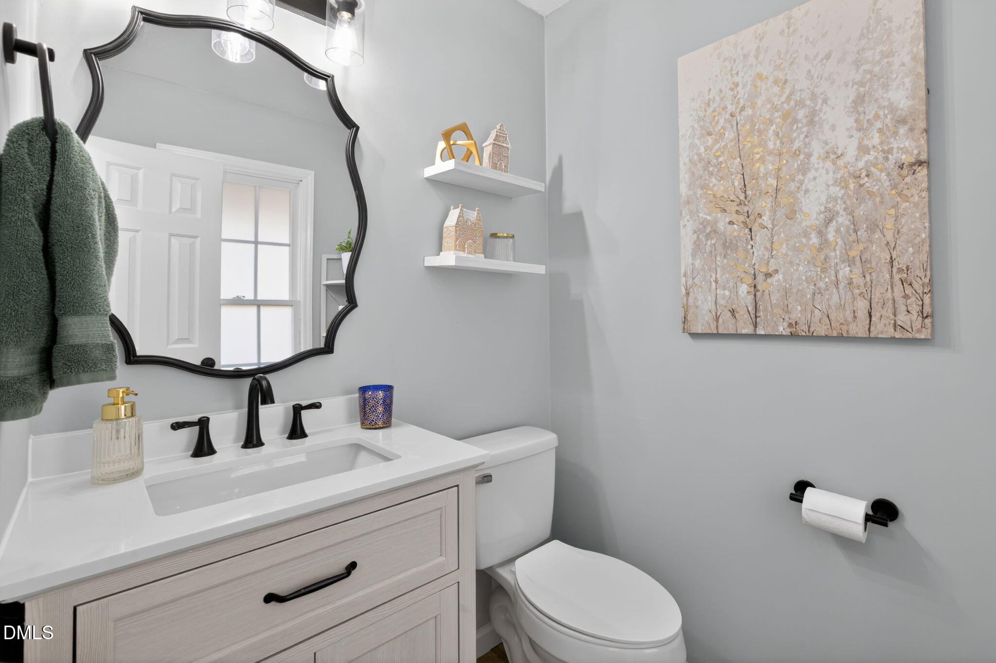 713 Marsh Grass Drive Raleigh, NC 27610 - Photo 36 of 41 a bathroom with a toilet sink and mirror