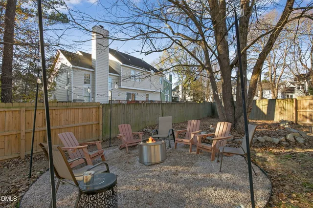 a view of a chairs and table in backyard