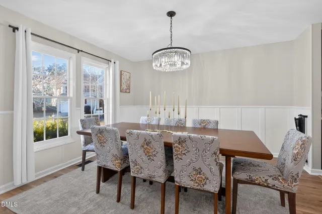 a view of a dining room with furniture wooden floor and a chandelier