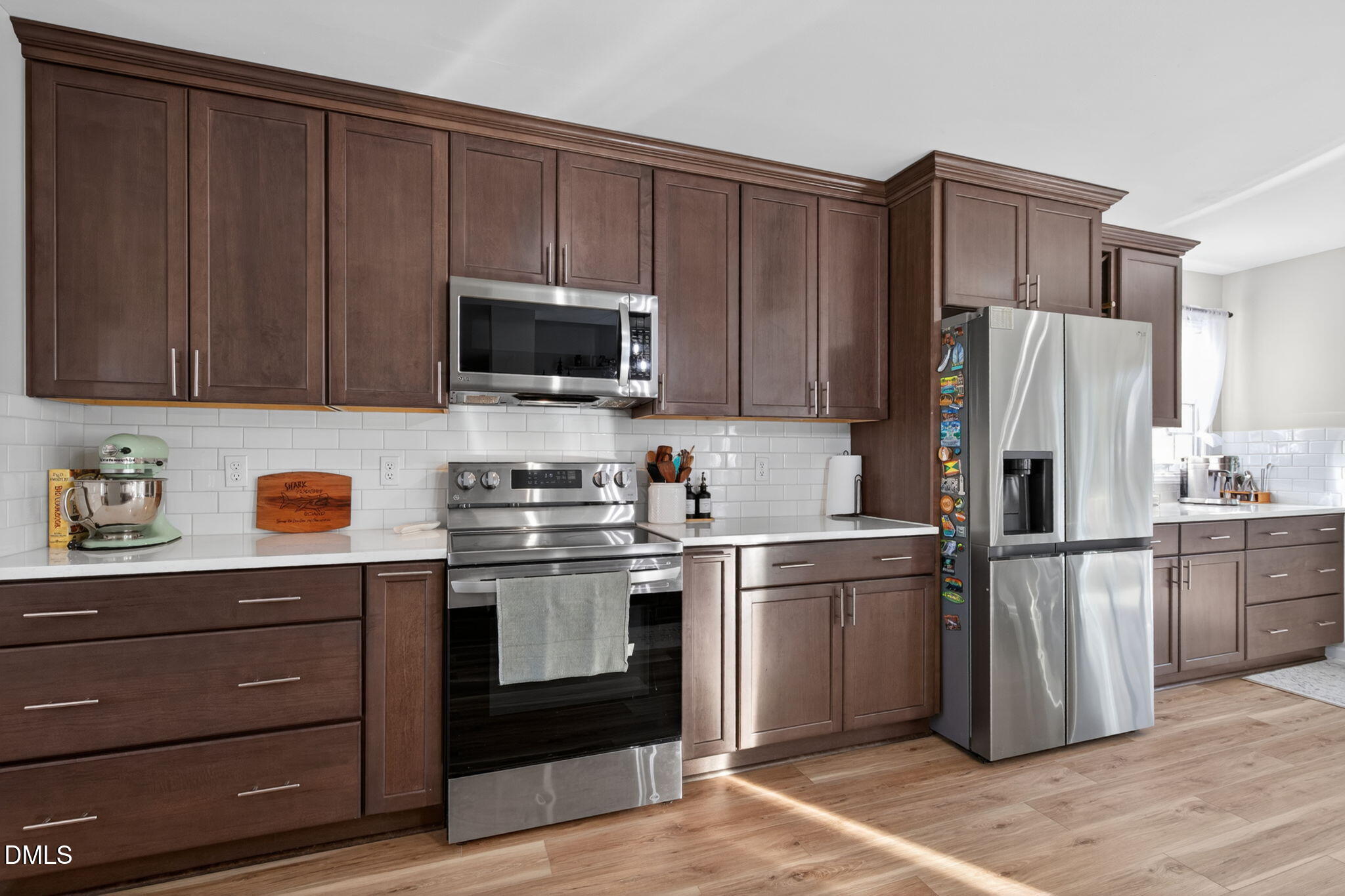 713 Marsh Grass Drive Raleigh, NC 27610 - Photo 7 of 41 a kitchen with granite countertop wooden cabinets and stainless steel appliances