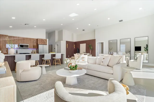 a living room with furniture and a view of kitchen