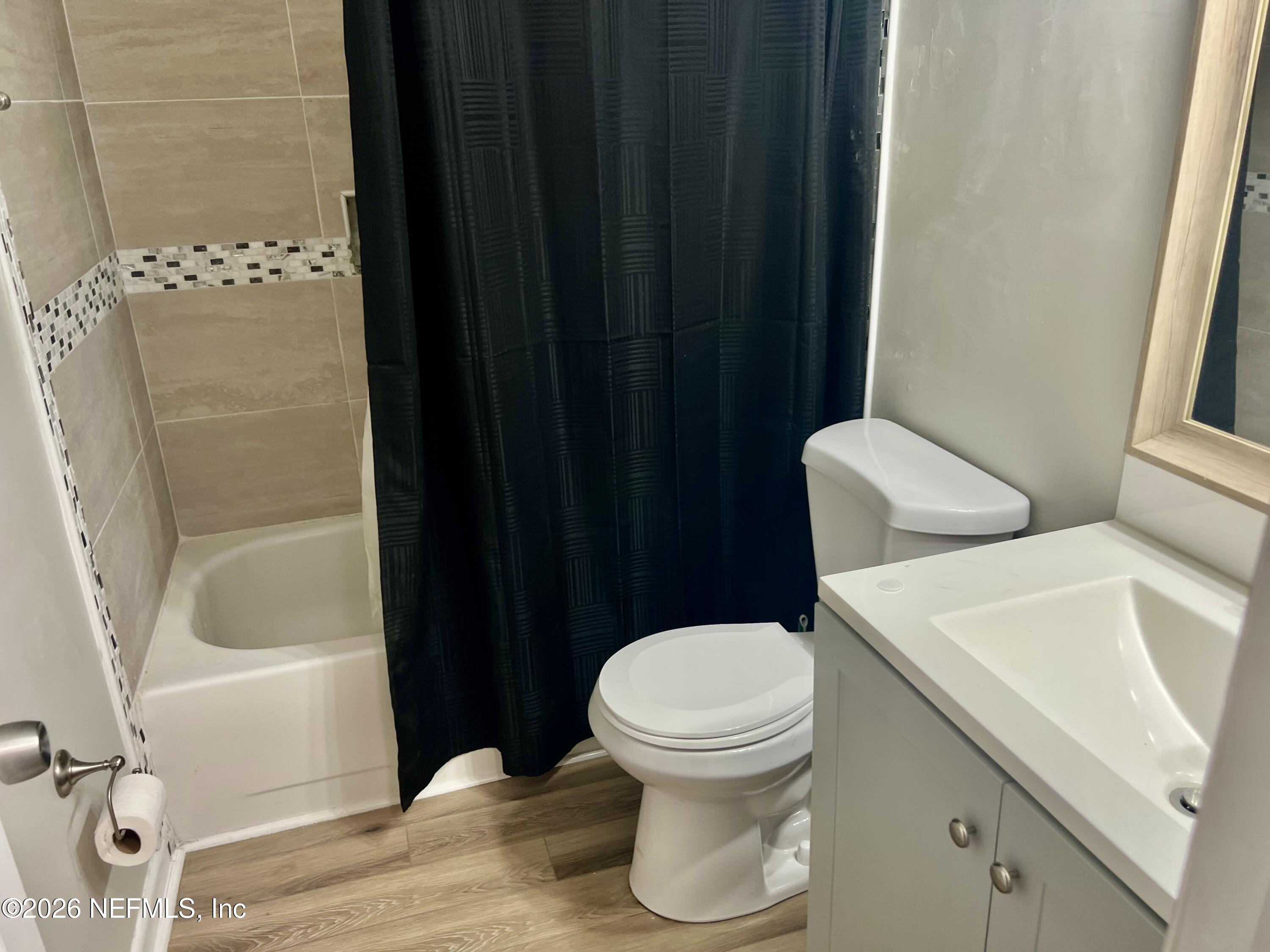 10964 Bacall Road West Jacksonville, FL 32218 - Photo 14 of 19 a white toilet sitting next to a bathroom sink