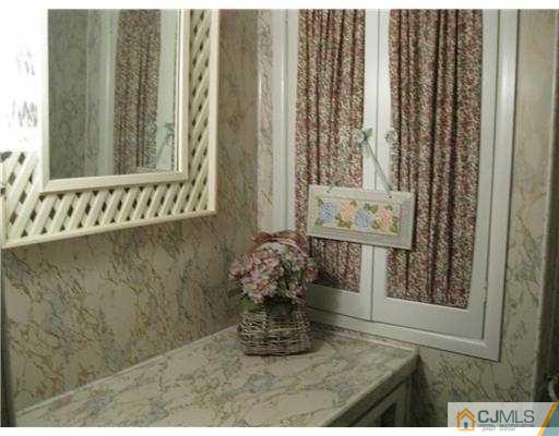 153 Oxford Road Colonia, NJ 07067 - Photo 12 of 13 a room with a mirror and a window