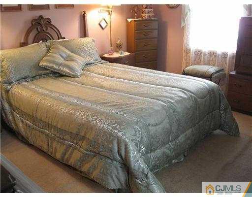 153 Oxford Road Colonia, NJ 07067 - Photo 4 of 13 a large bed sitting in a bedroom next to a window