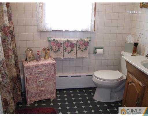 153 Oxford Road Colonia, NJ 07067 - Photo 5 of 13 a bathroom with a toilet and a sink