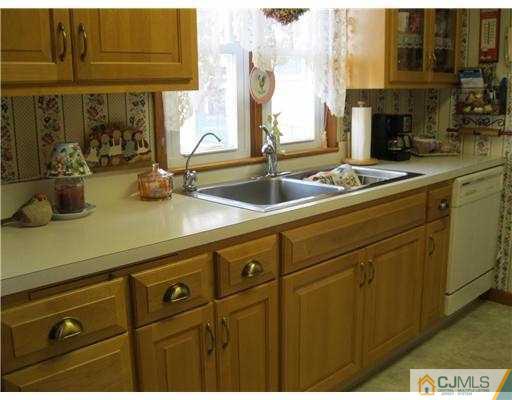 153 Oxford Road Colonia, NJ 07067 - Photo 9 of 13 a kitchen with sink and mirror