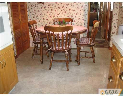 153 Oxford Road Colonia, NJ 07067 - Photo 10 of 13 a view of a dining room with furniture and a chandelier