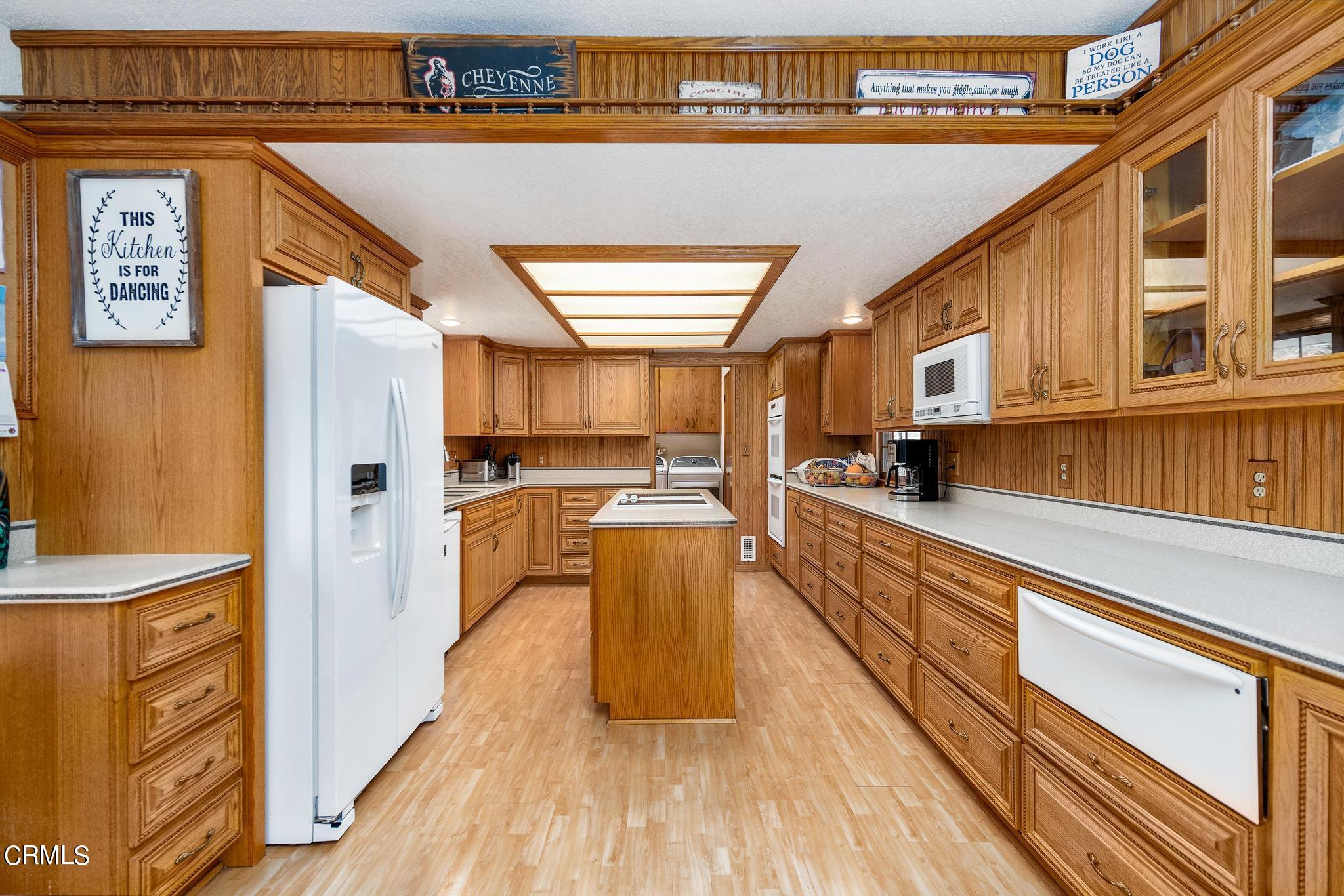 1138 Spring Street Oak View, CA 93022 - Photo 15 of 38 a kitchen with stainless steel appliances granite countertop a refrigerator a stove and a wooden floors