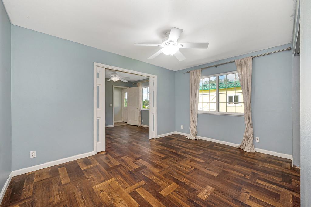 6181 Lambert Lane El Dorado, CA 95623 - Photo 36 of 68 unfurnished room featuring healthy amount of natural light, dark wood-type flooring, and ceiling fan