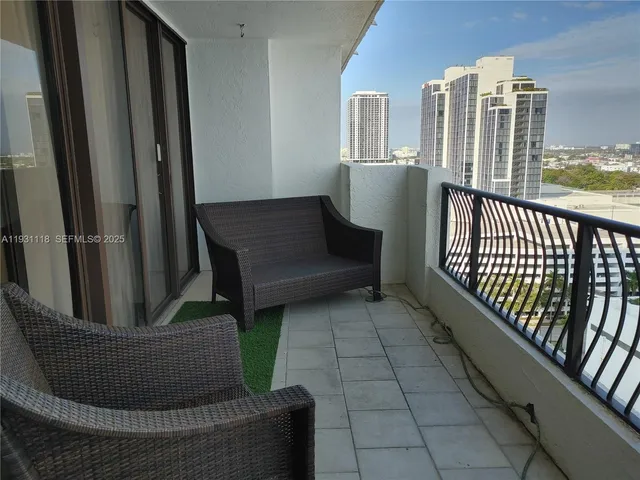 a view of balcony with furniture