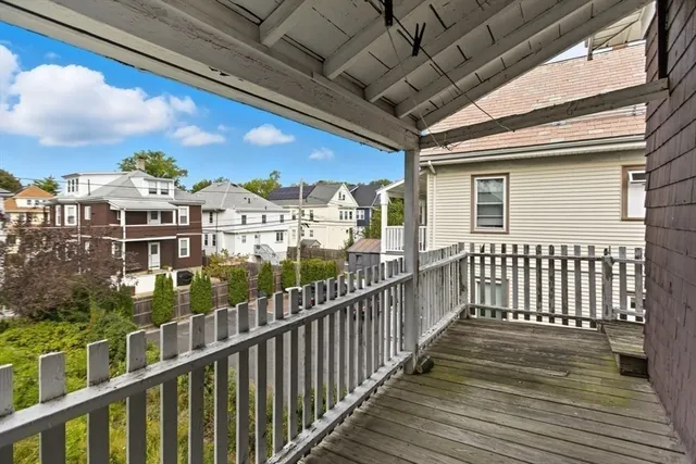 a view of a balcony with wooden floor