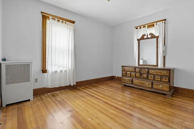 a view of a room with wooden floor and cabinet