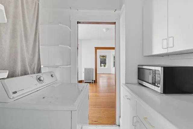 a view of washer and dryer with kitchen in the background