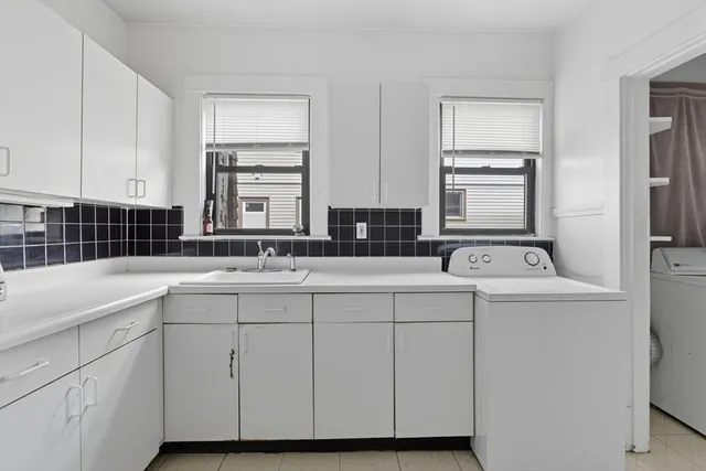 a bathroom with a sink and a window