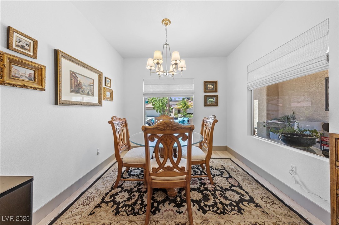 550 Kings Links Street Henderson, NV 89012 - Photo 13 of 36 Dining room with a chandelier and light wood-style floors