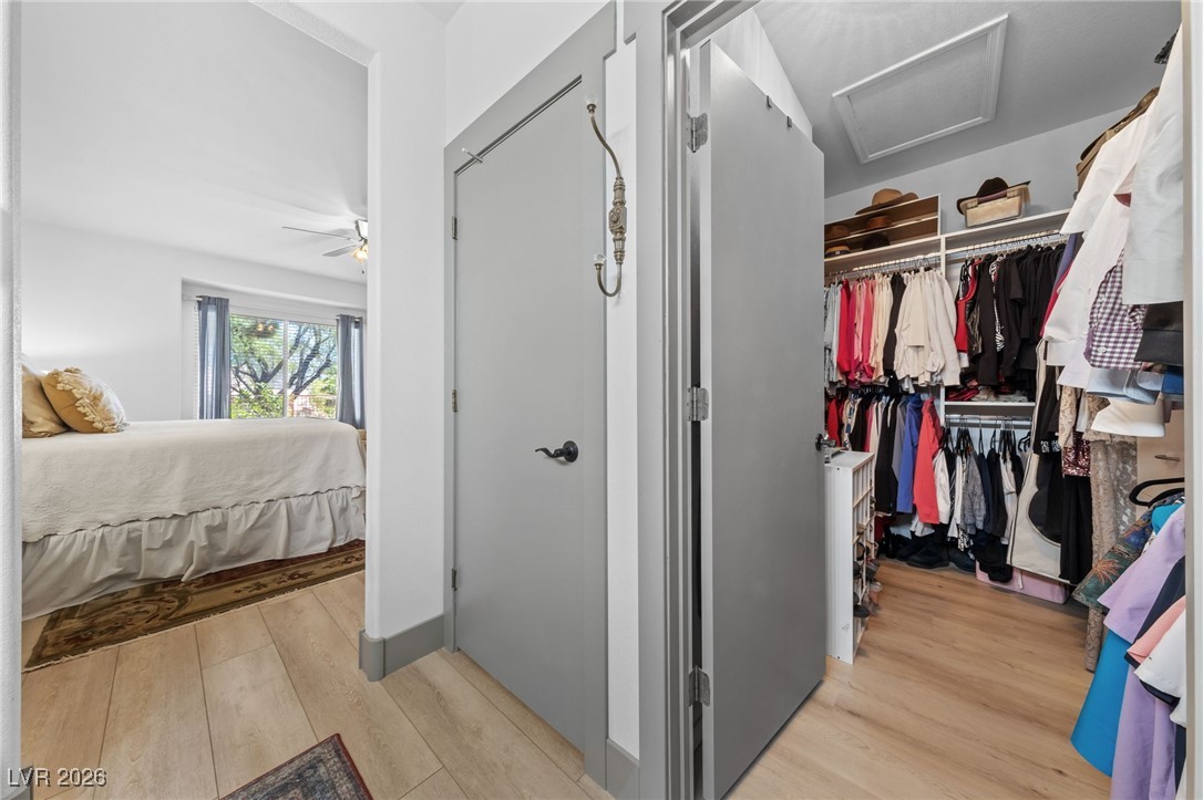 550 Kings Links Street Henderson, NV 89012 - Photo 16 of 36 Walk in closet with light wood-type flooring, attic access, and a ceiling fan