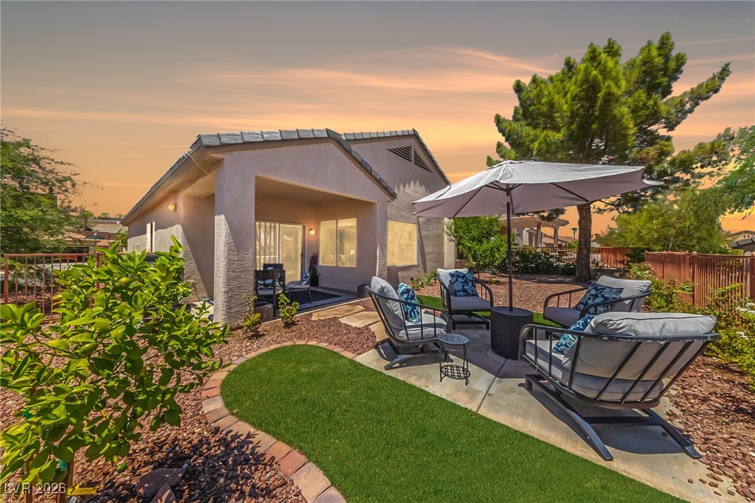 550 Kings Links Street Henderson, NV 89012 - Photo 22 of 36 Rear view of house with a patio, stucco siding, and an outdoor living space