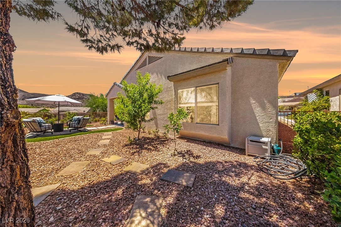 550 Kings Links Street Henderson, NV 89012 - Photo 24 of 36 View of side of property with stucco siding and a patio area