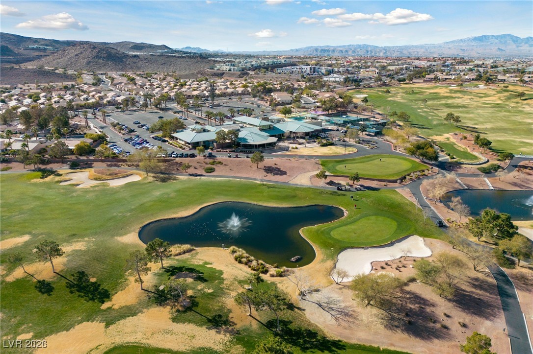 550 Kings Links Street Henderson, NV 89012 - Photo 31 of 36 Aerial view of property and surrounding area with nearby suburban area, a water and mountain view, and a golf course