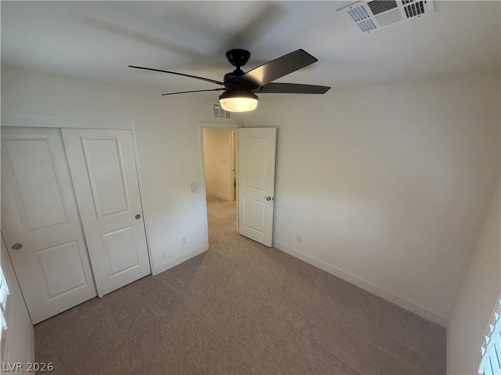 7879 Shoreline Ridge Court Las Vegas, NV 89166 - Photo 19 of 26 Clean lines and neutral carpeting define this comfortable secondary bedroom.