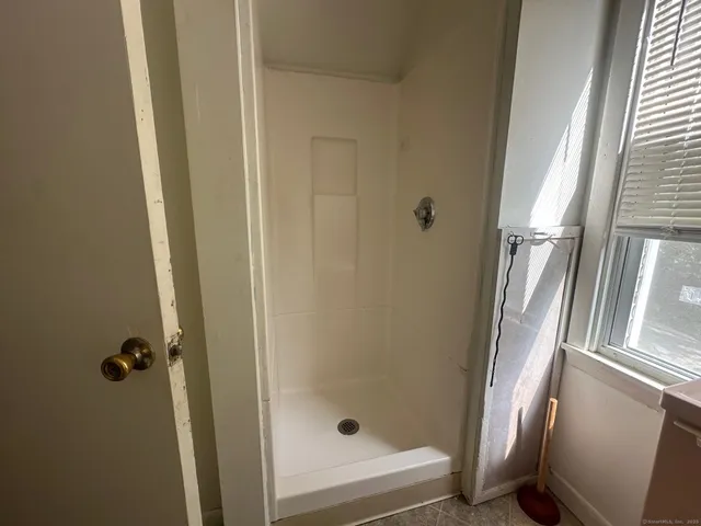 a bathroom with a glass door shower