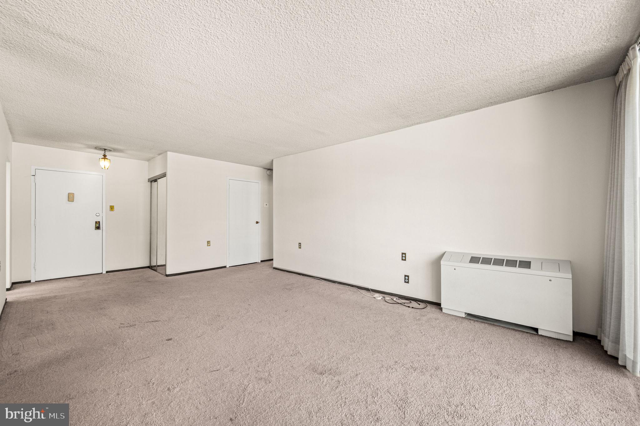 801 Yale Avenue, Unit 511 Swarthmore, PA 19081 - Photo 5 of 28 Living room view of foyer and coat closet.