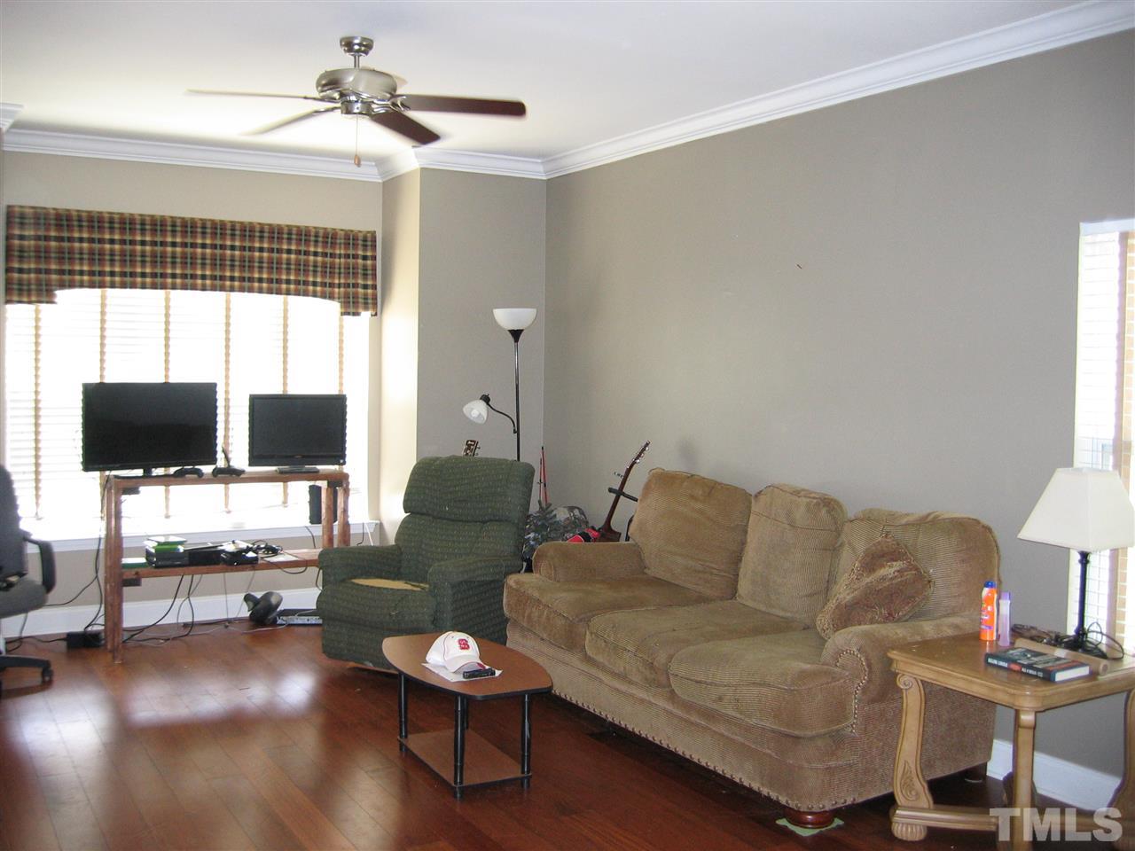 2840 Barrymore Street, Unit 105 Raleigh, NC 27603 - Photo 3 of 9 a living room with furniture and a flat screen tv