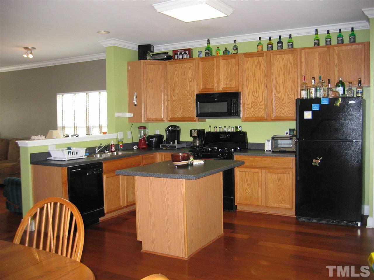 2840 Barrymore Street, Unit 105 Raleigh, NC 27603 - Photo 4 of 9 a kitchen with stainless steel appliances granite countertop a refrigerator a stove a sink and a microwave