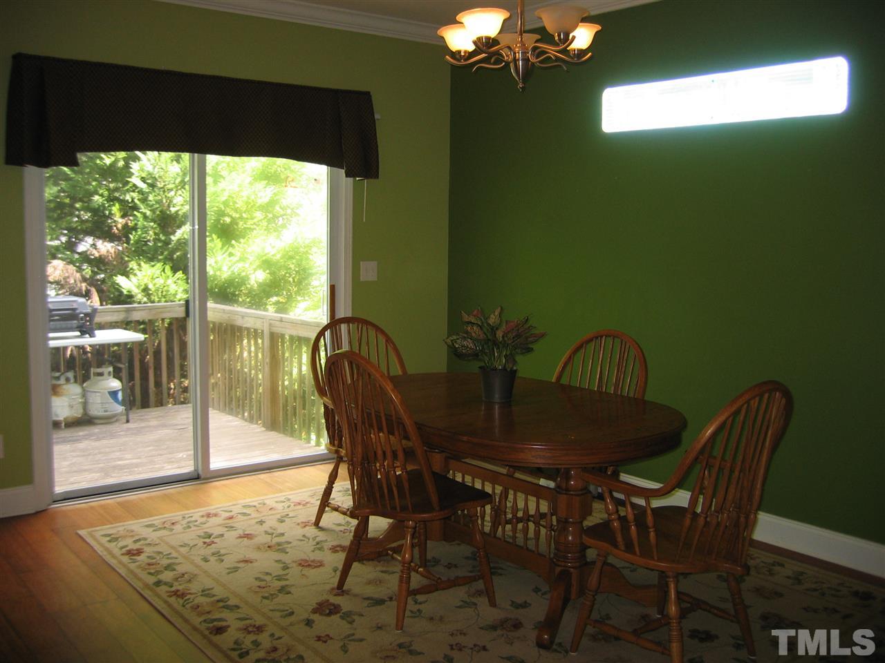 2840 Barrymore Street, Unit 105 Raleigh, NC 27603 - Photo 5 of 9 a view of a dining room with furniture and chandelier