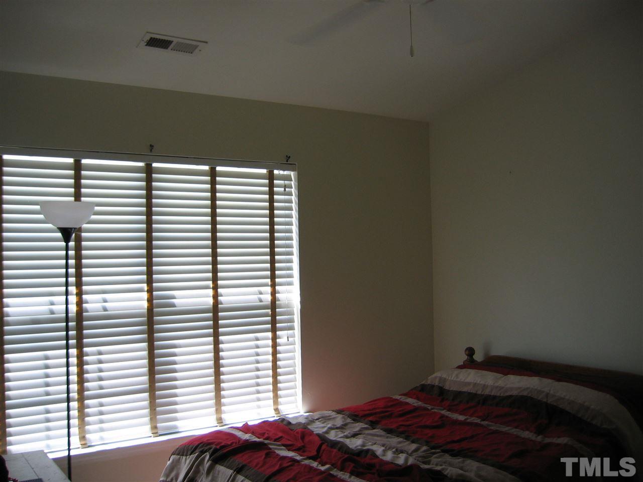 2840 Barrymore Street, Unit 105 Raleigh, NC 27603 - Photo 7 of 9 a bedroom with a bed and a window